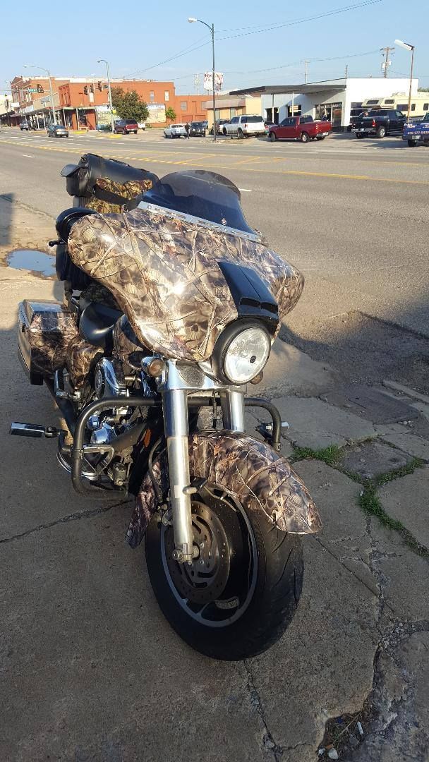 A motorcycle is parked on the side of the road in a parking lot.