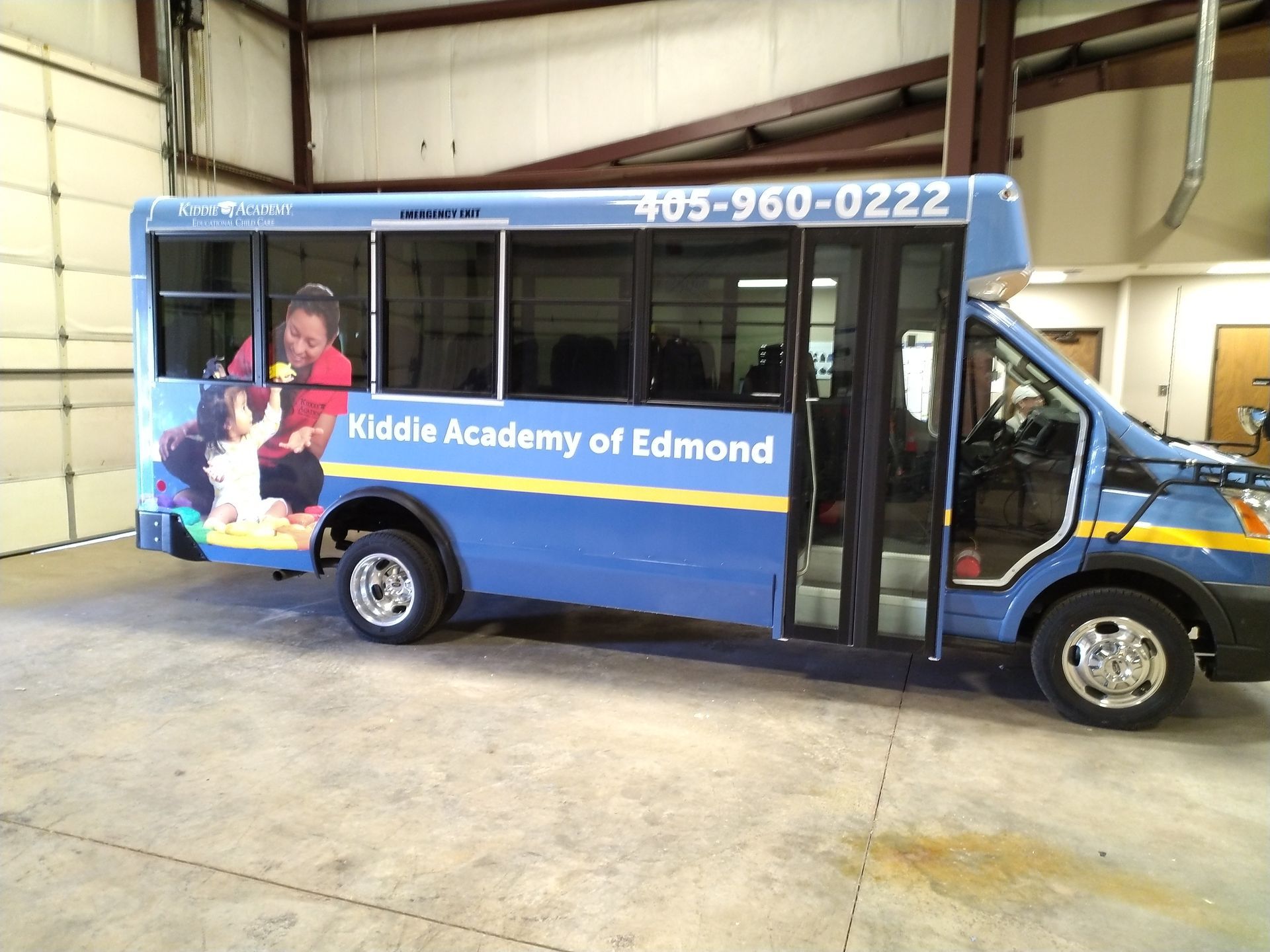 A blue bus that says middle academy of edmond on the side
