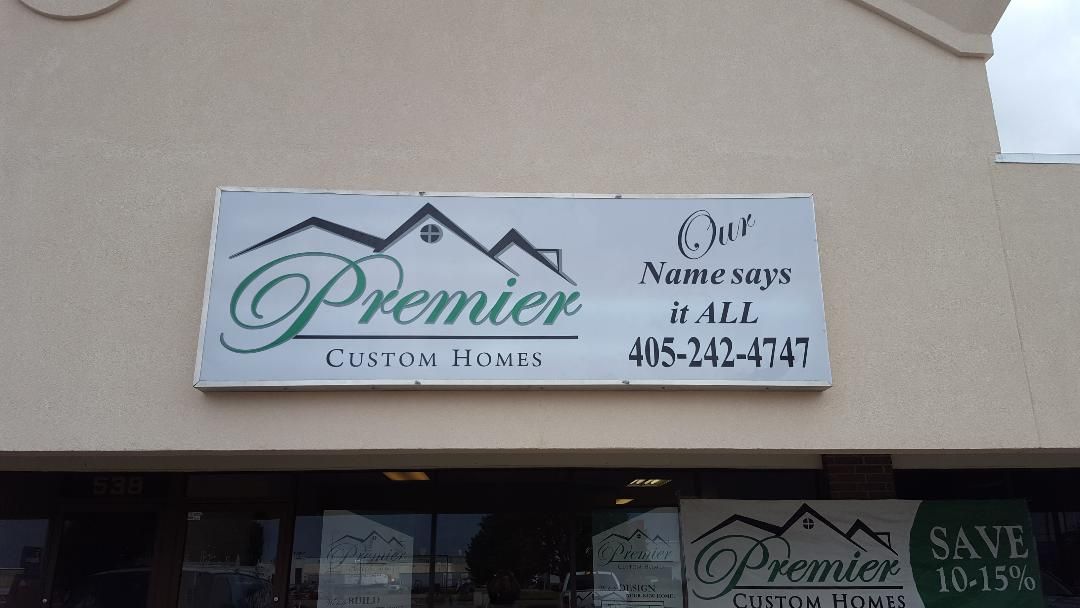 A sign on the side of a building that says premier custom homes