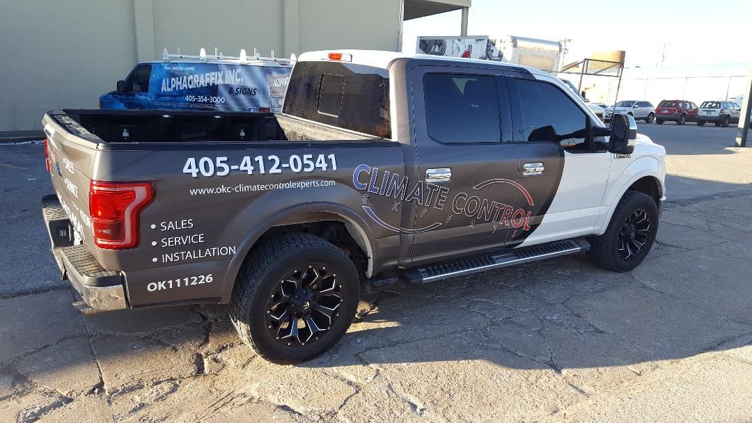 A black and white truck is parked in a parking lot.