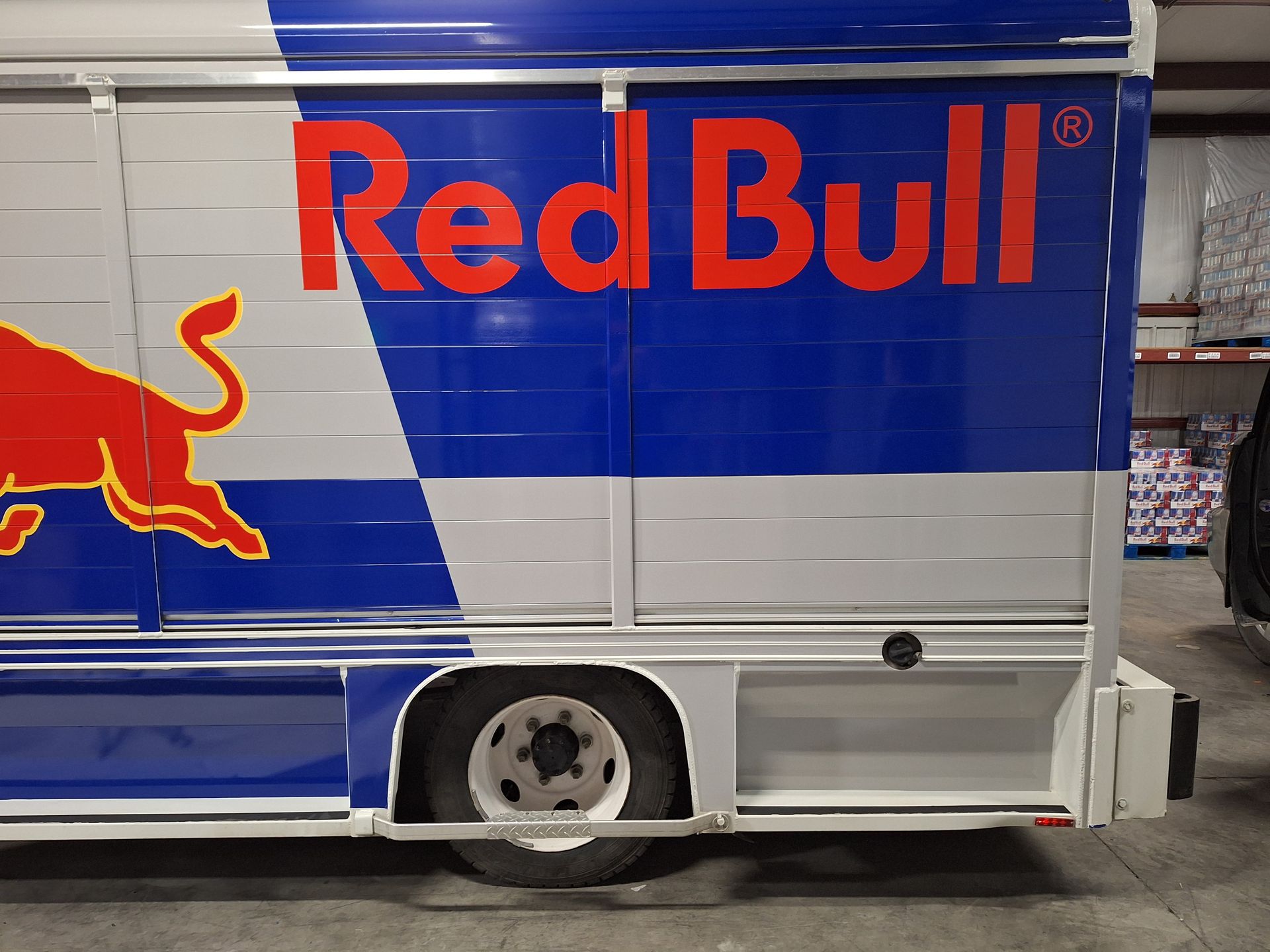 A red bull truck is parked in a warehouse