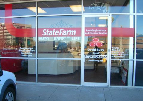 A car is parked in front of a state farm store