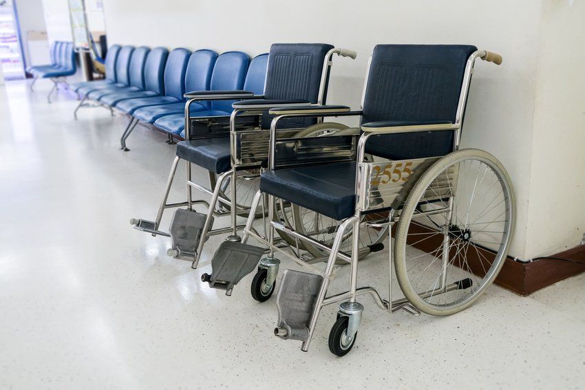 Two wheelchairs are sitting next to each other in a hospital waiting room