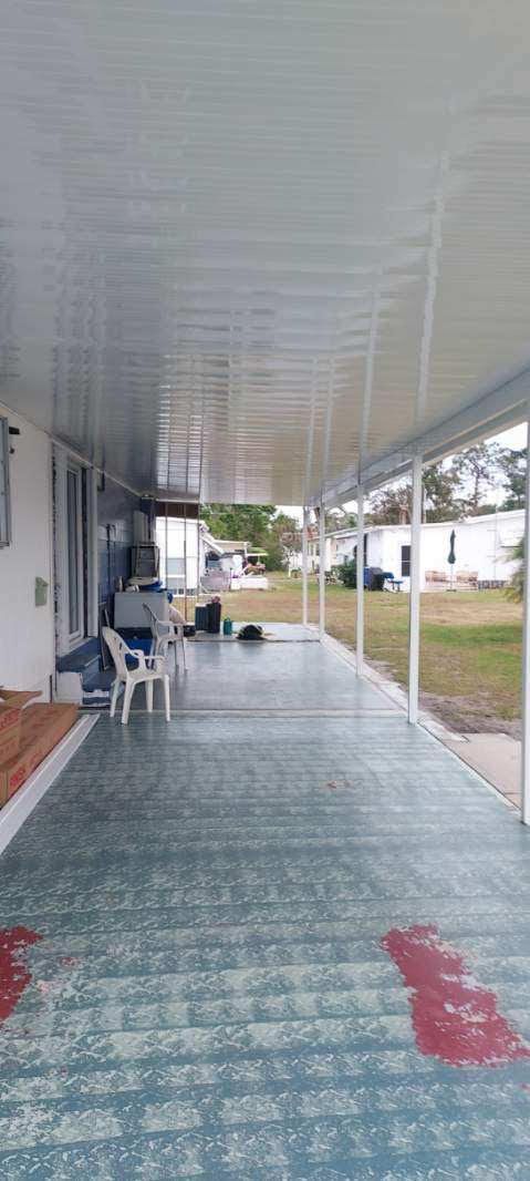 A long covered walkway leading to a house.