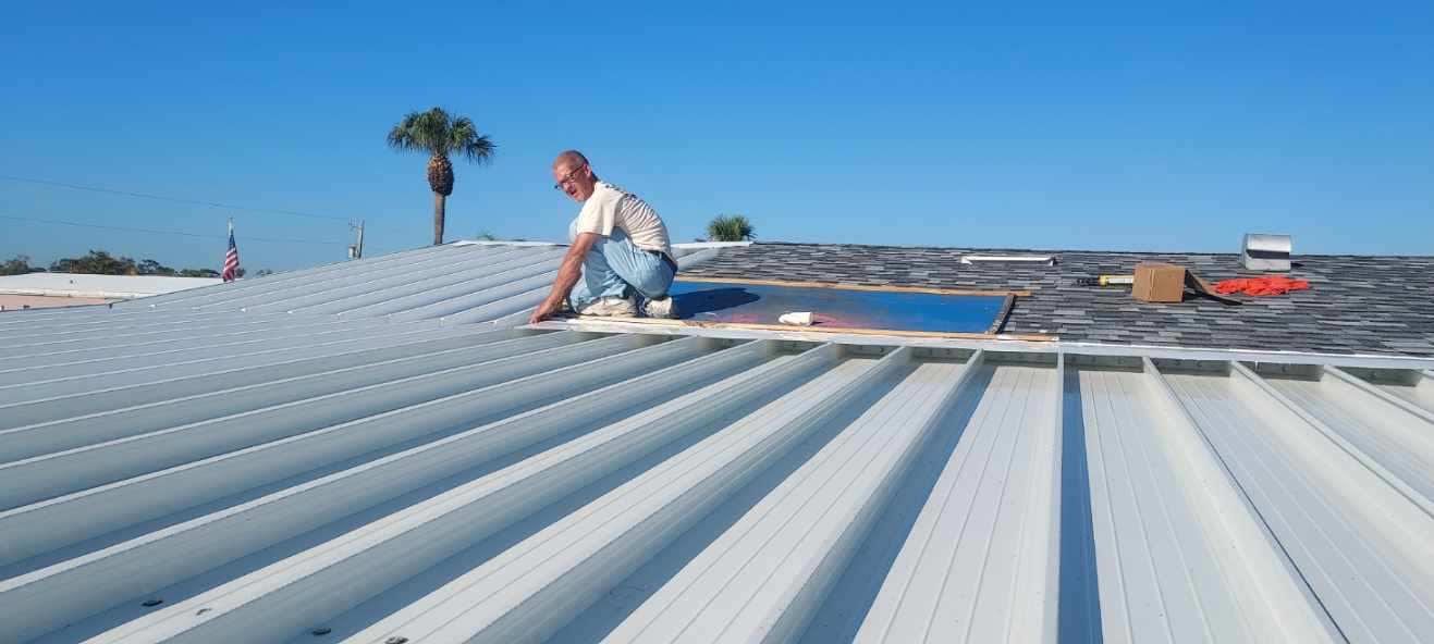A man is working on the roof of a building.