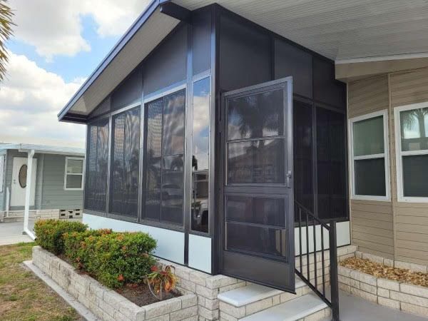 A house with a screened in porch and stairs