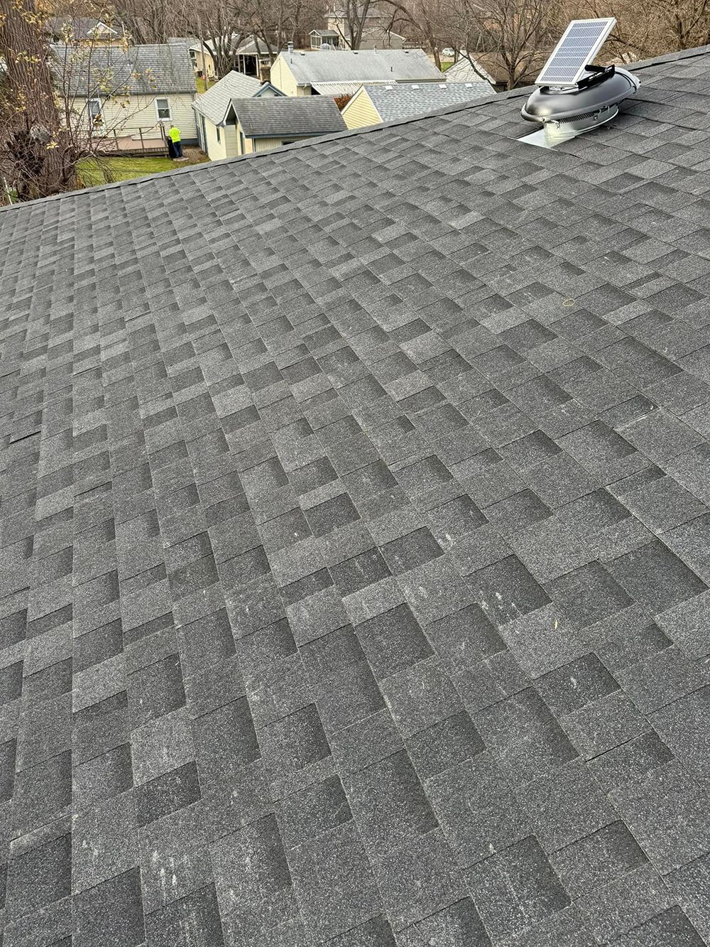 A close up of a roof with a solar panel on top of it