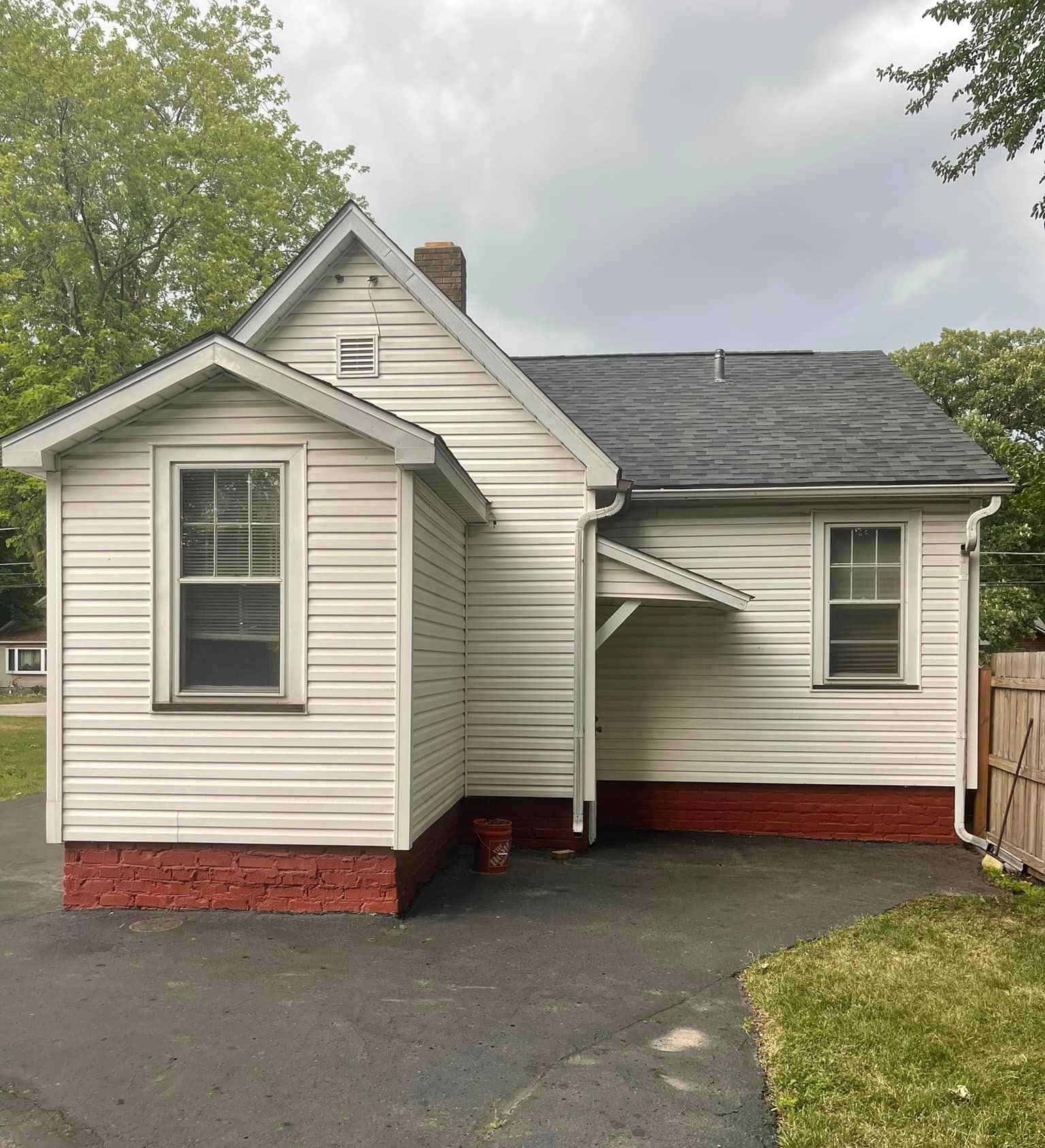 A small white house with a black roof