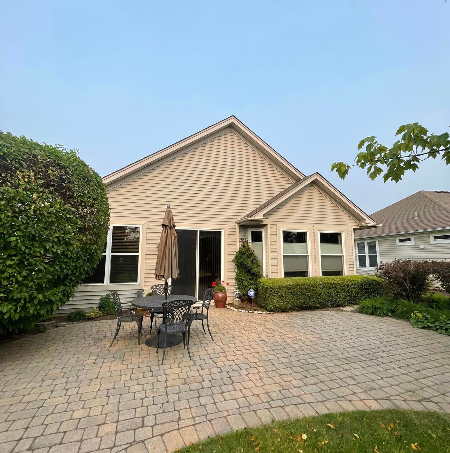A house with a table and chairs in front of it