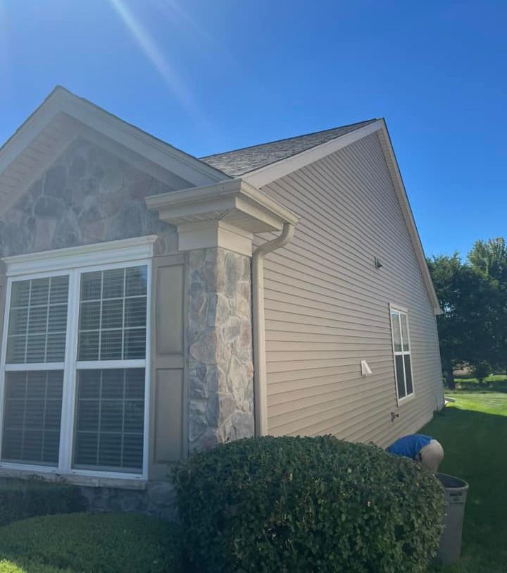 A house with a lot of windows and a blue sky in the background