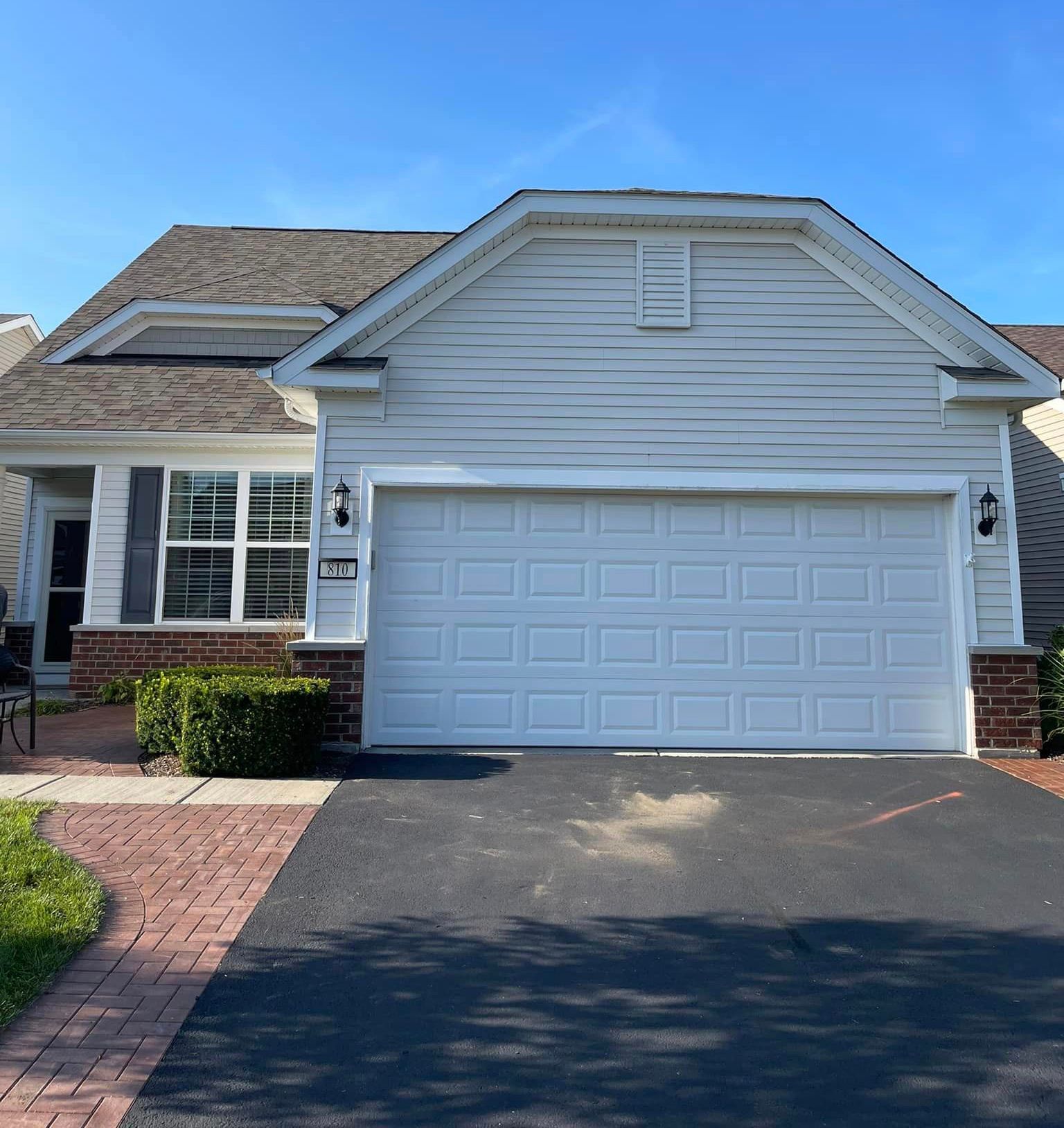 The front of a house with a white garage door