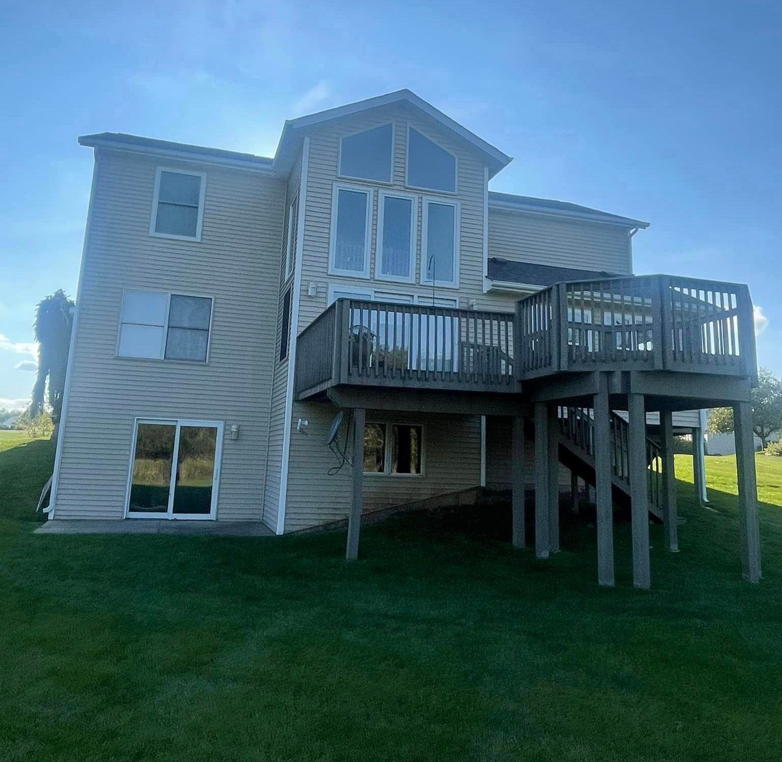 A large house with a large deck and stairs