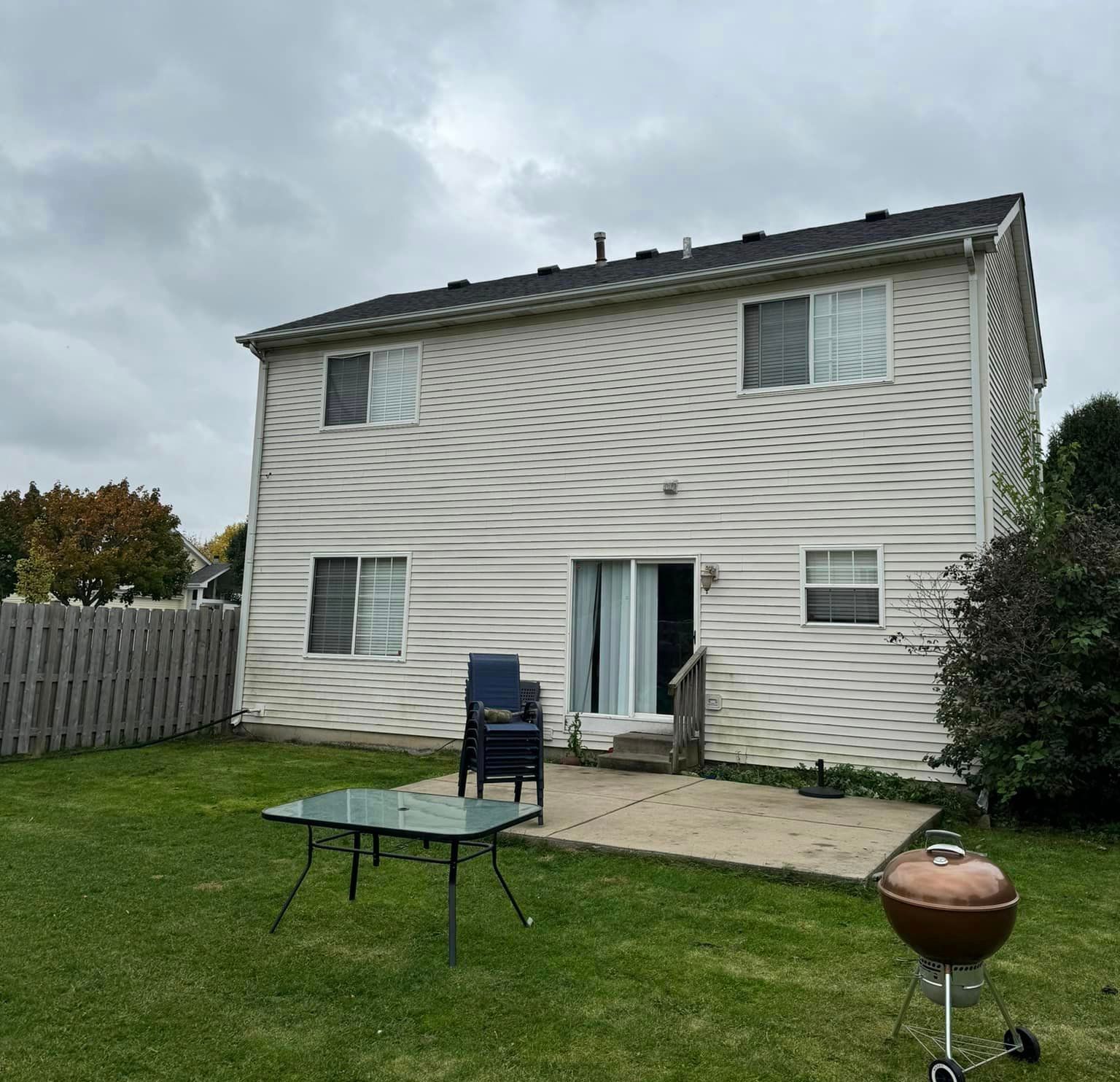 A house with a table and chairs in front of it
