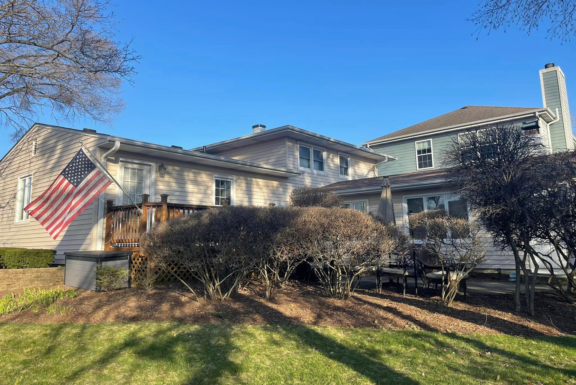 A large house with a large american flag on the side of it