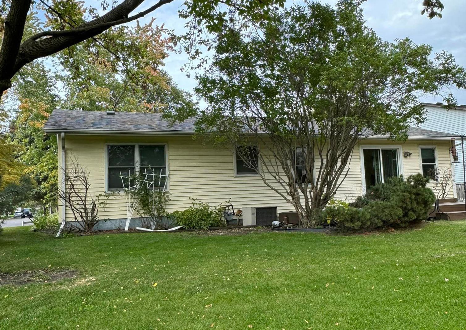 A house with a large lawn in front of it
