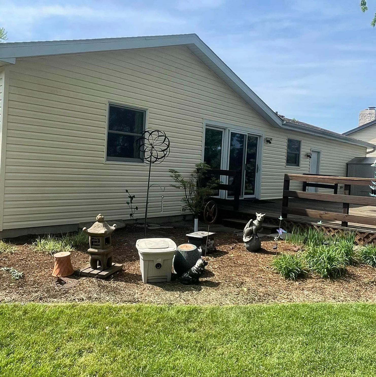 A white house with a fence and a lot of statues in front of it