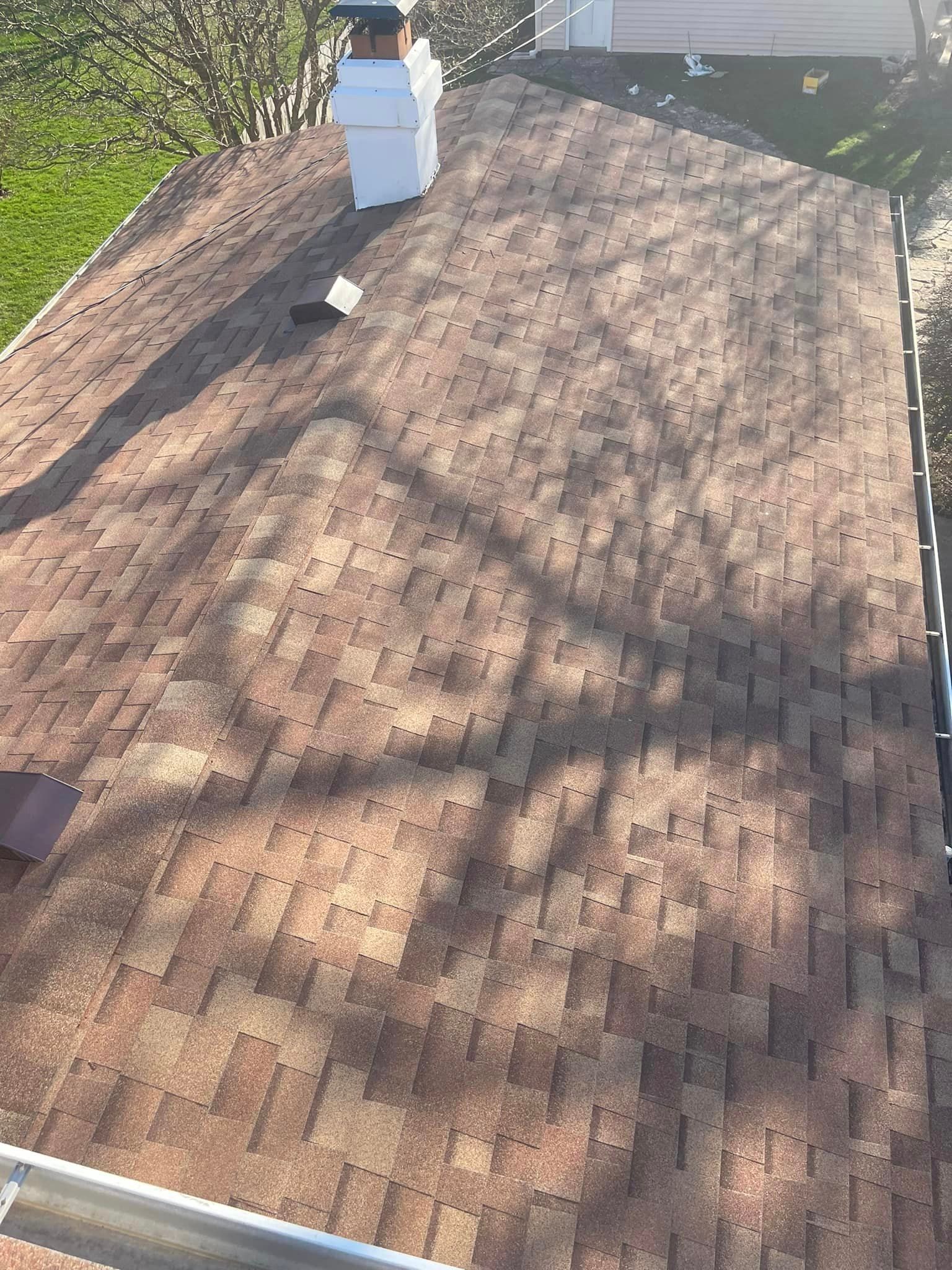 An aerial view of a roof with a chimney on top of it
