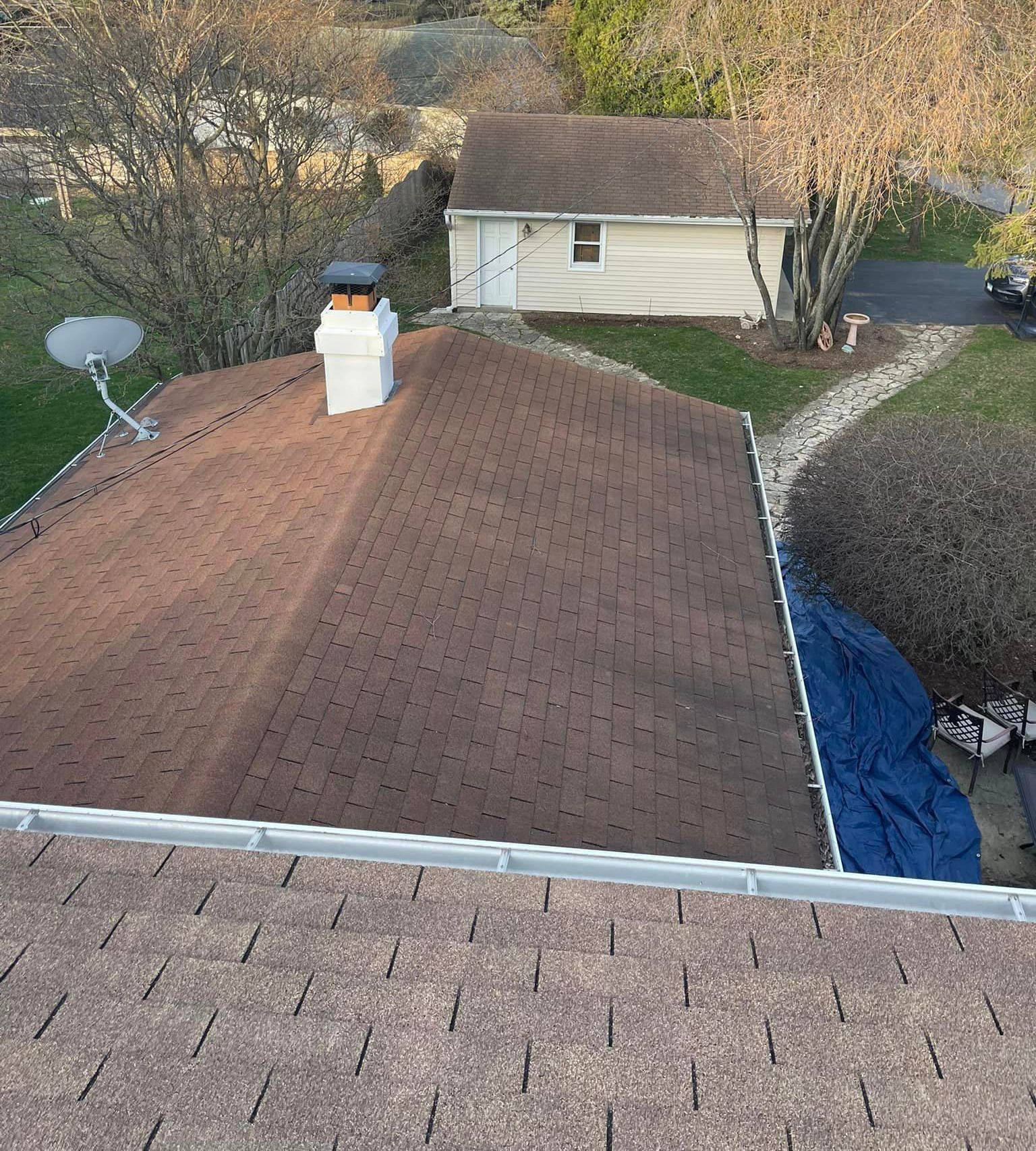 An aerial view of a house with a roof and a chimney
