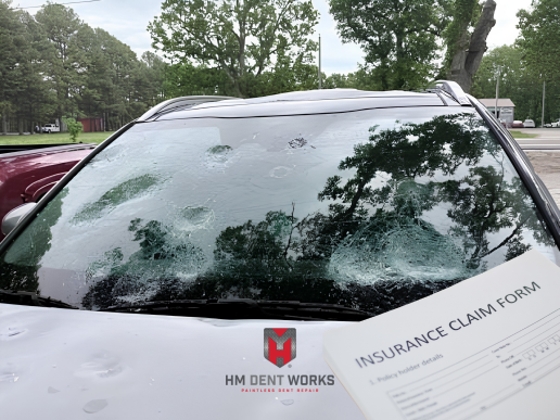 Vehicle owner reviewing insurance paperwork after hail damage in Springfield, MO