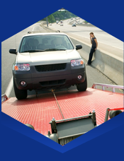 A vehicle being pulled onto a tow truck