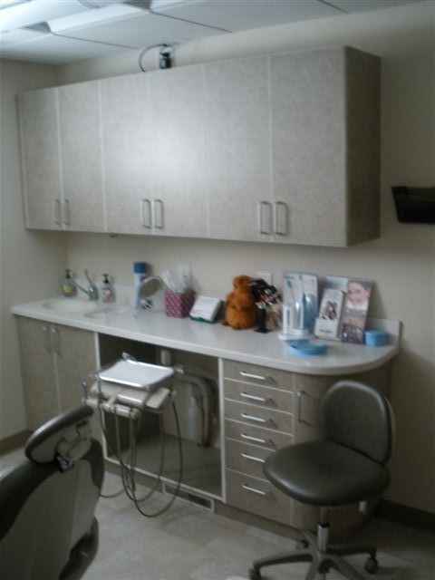 beautiful taupe colored dental cabinet near the dental chair