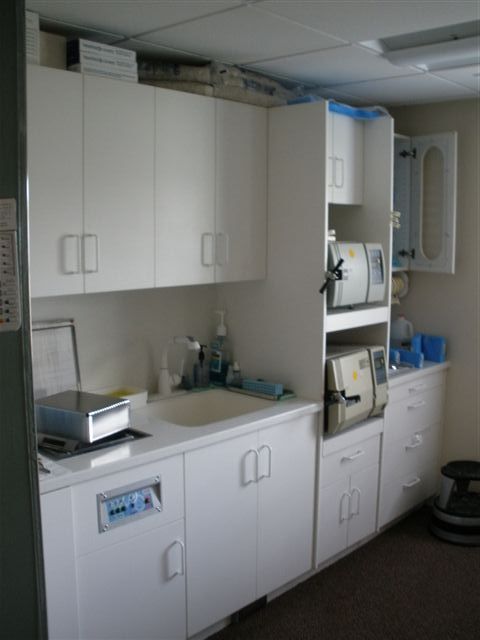 white dental cabinet with sink and counter
