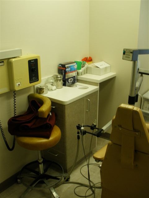small dental table and cabinet and brown dental chairs