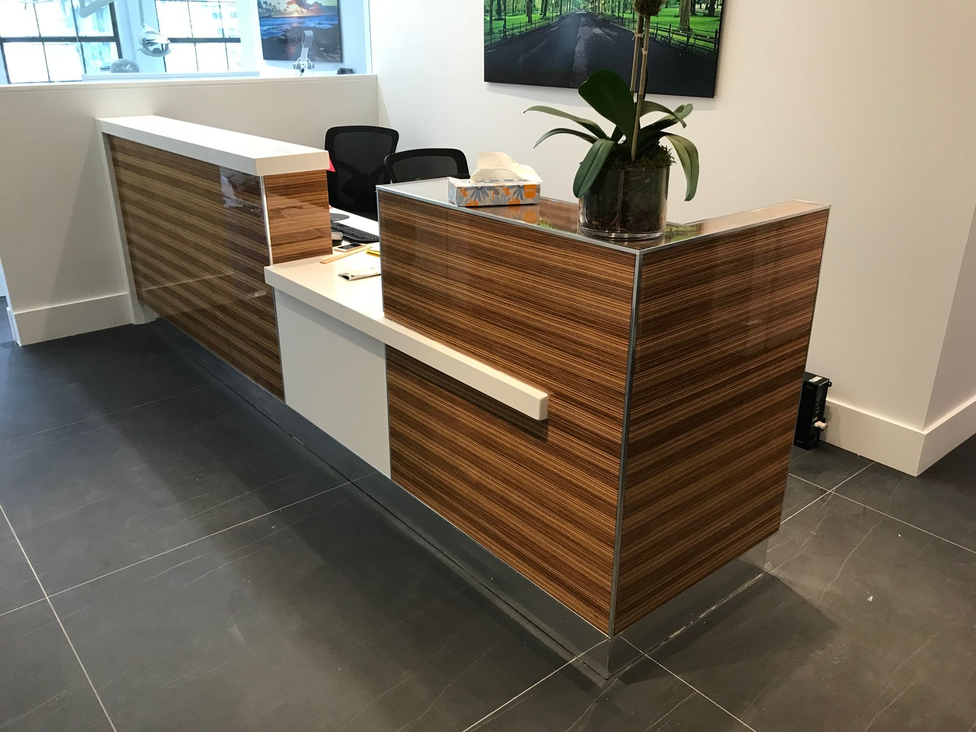 white and brown front desk with a plant on top