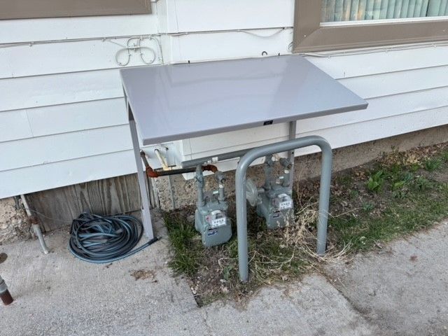 A table with two gas meters on it in front of a house