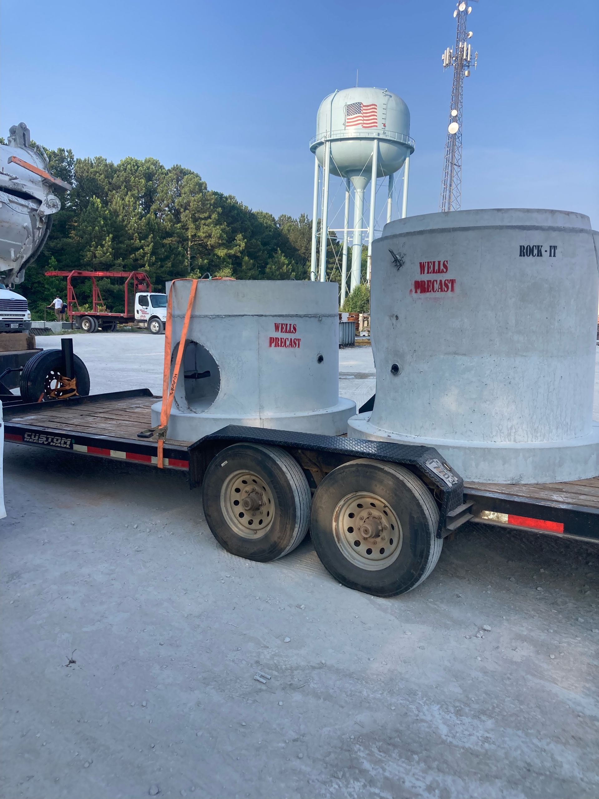 A trailer with a water tower in the background
