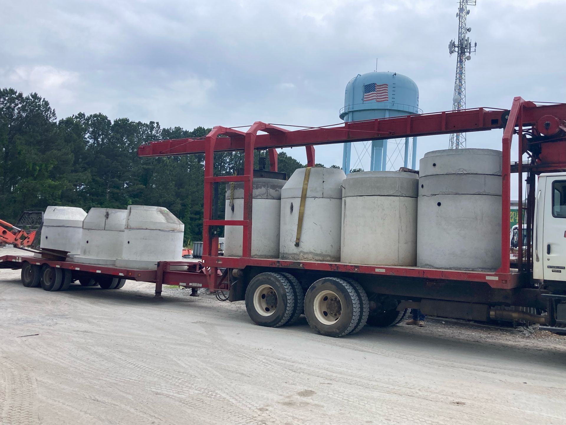 A semi truck is carrying concrete blocks on a trailer