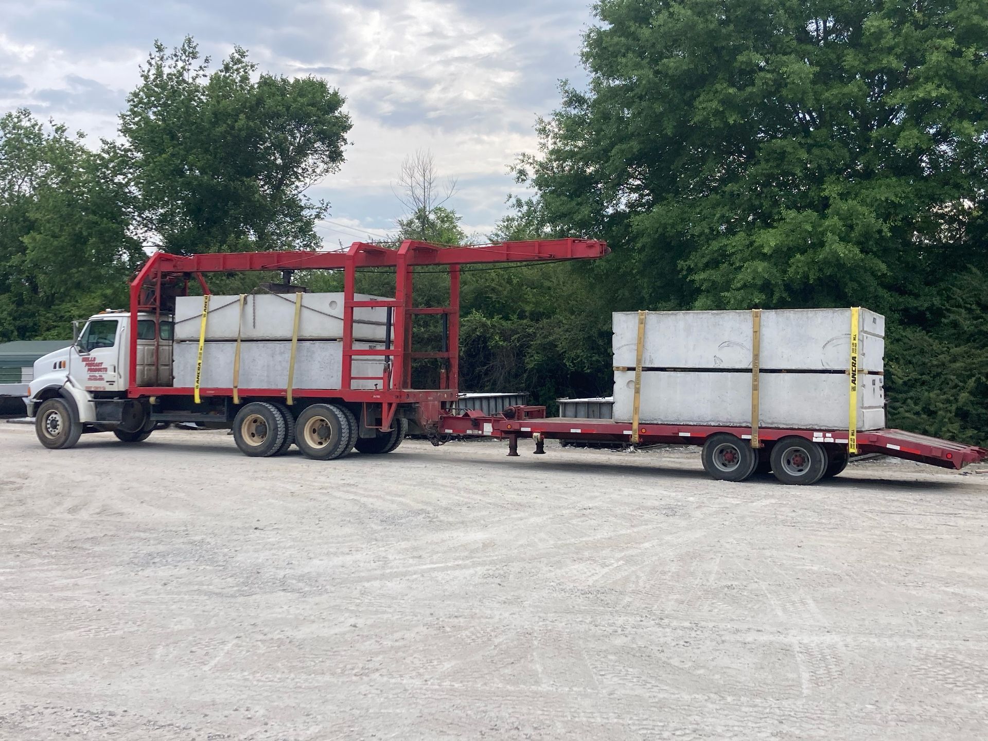 A truck is carrying concrete blocks on a trailer
