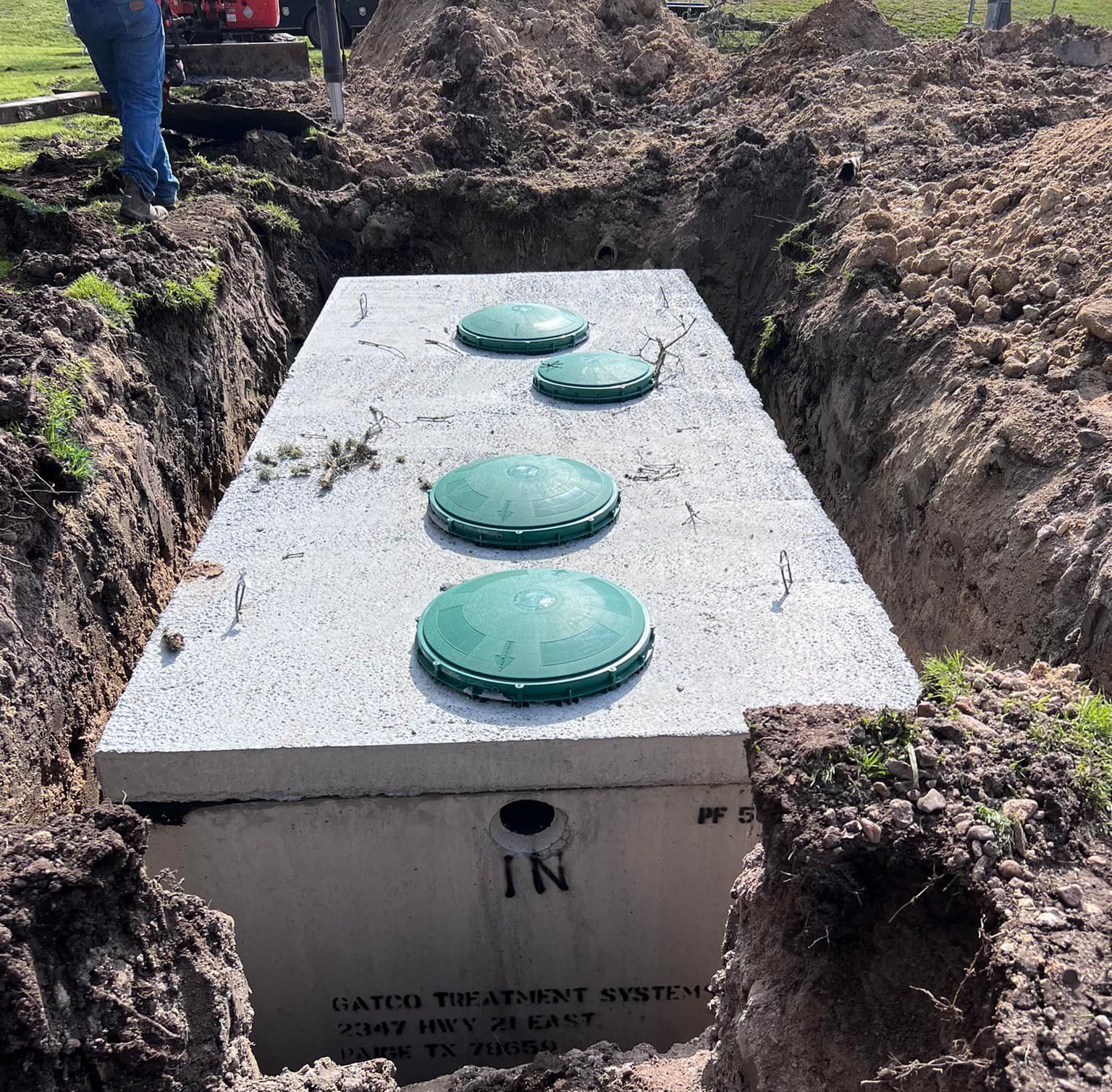 A septic tank is being installed in the dirt