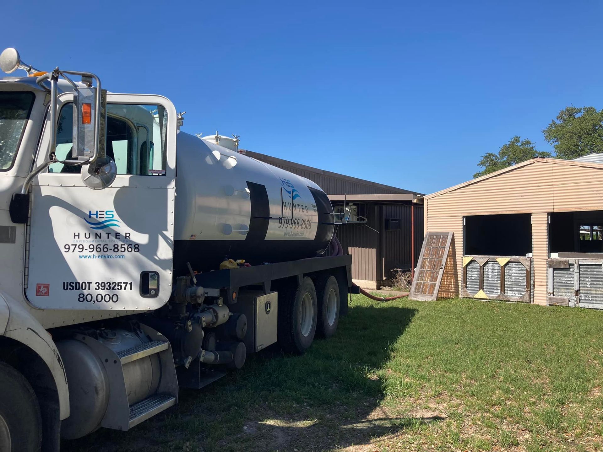 A large white truck is parked in front of a house.