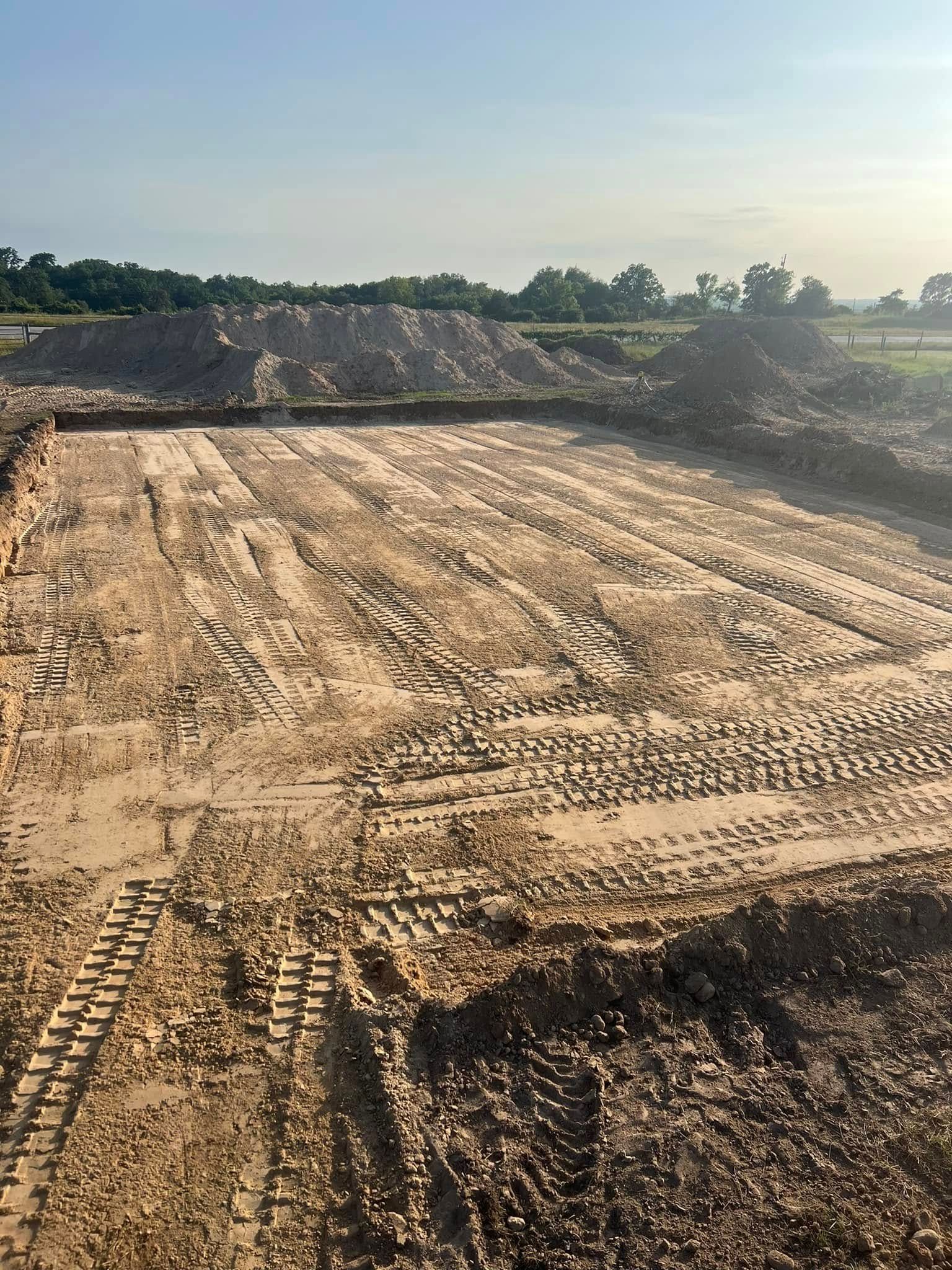 A large pile of dirt is sitting on top of a dirt field.