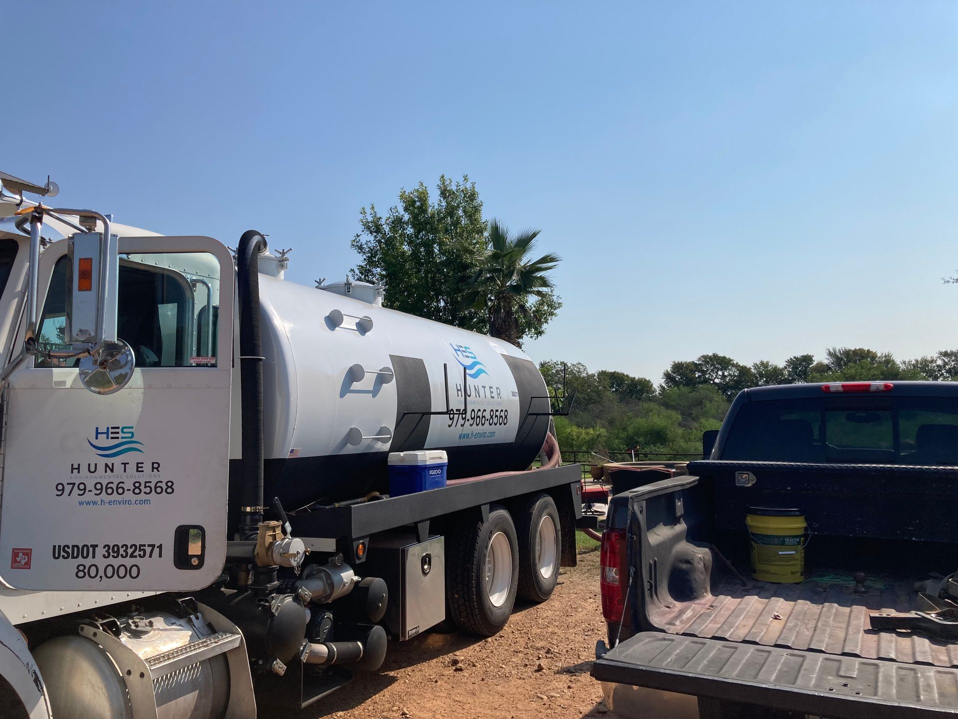 A tanker truck is parked next to a truck