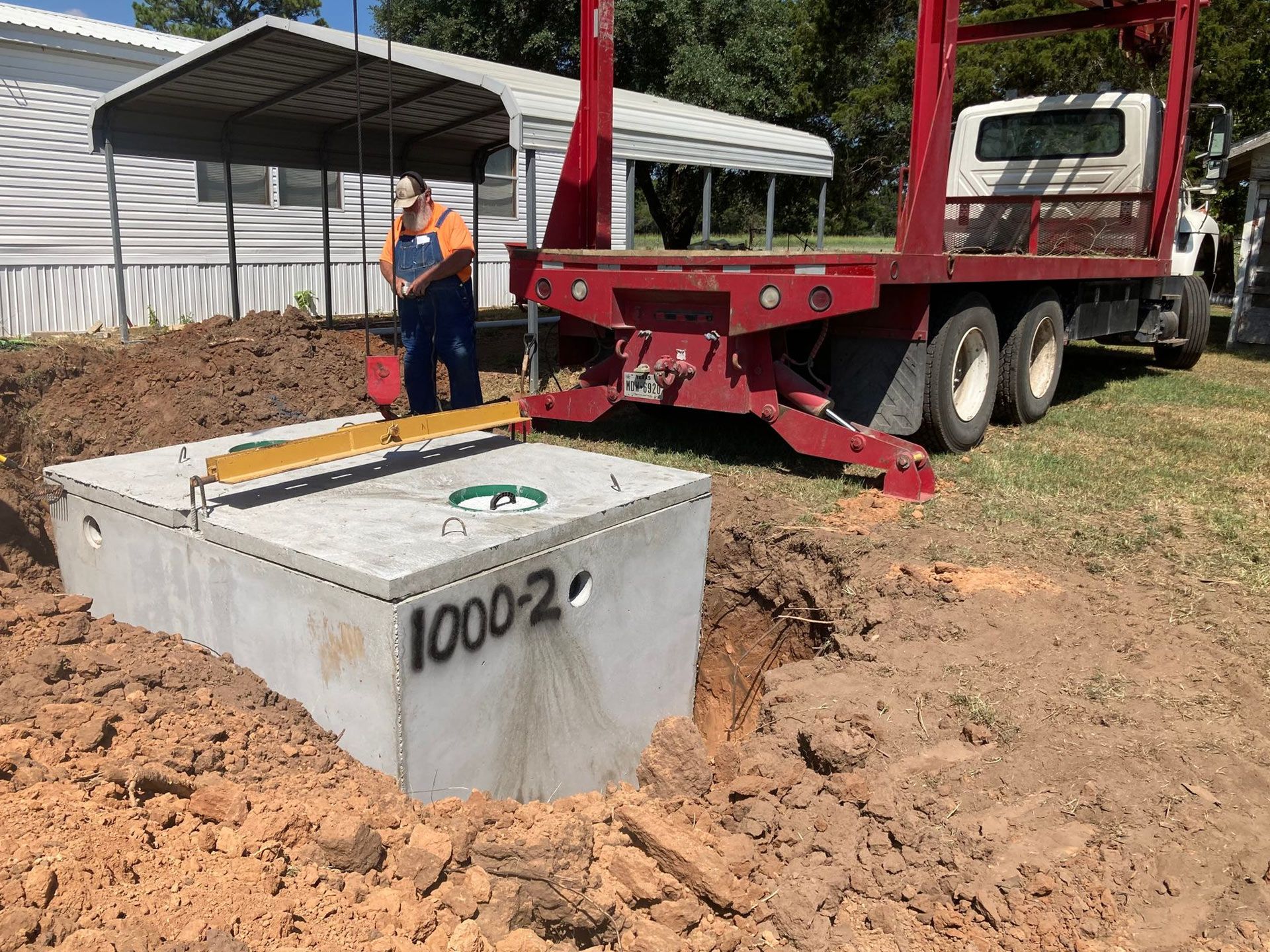 A man is standing next to a large concrete box