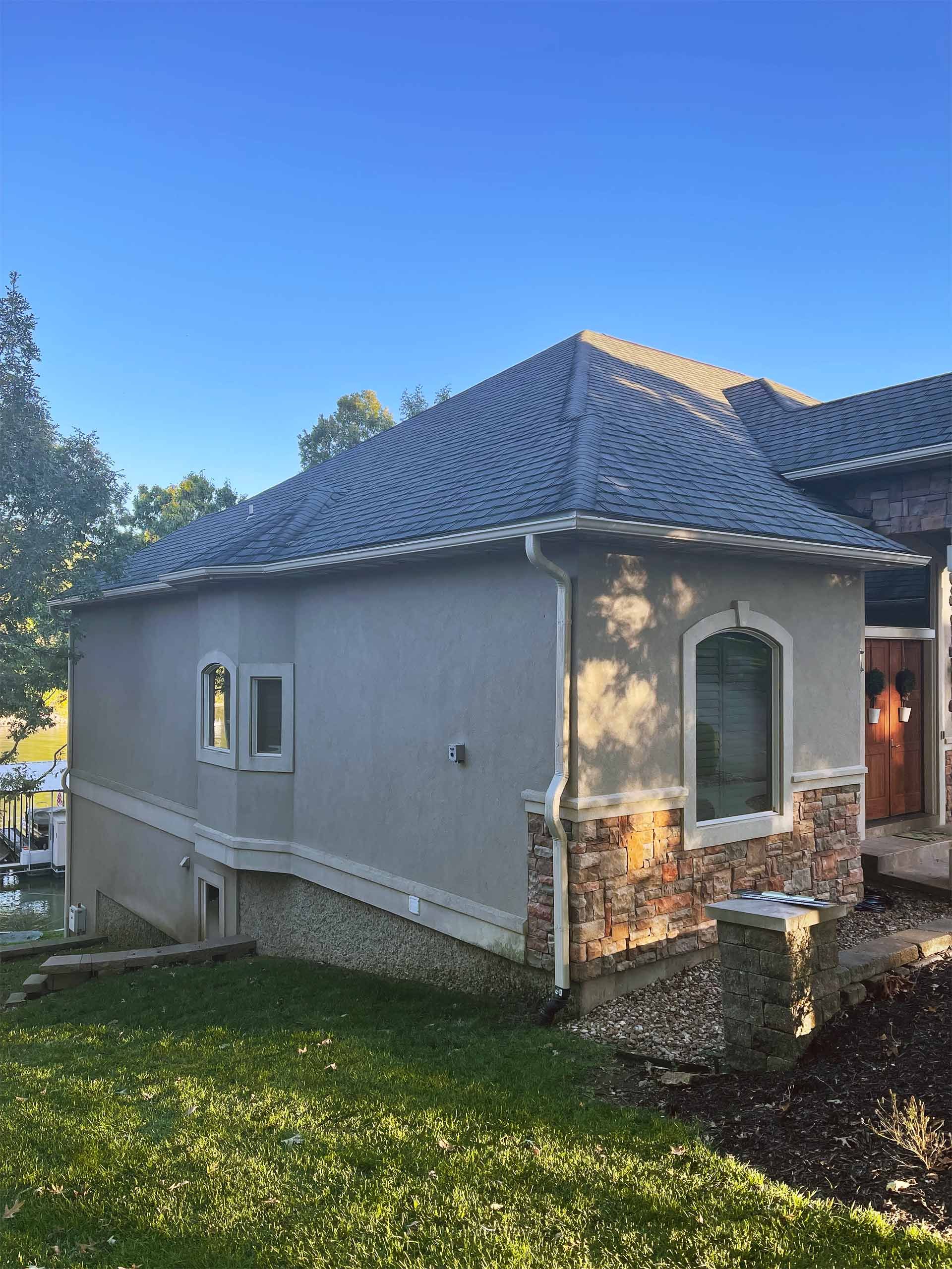 House exterior with stucco walls, stone accents, and tiled roof.