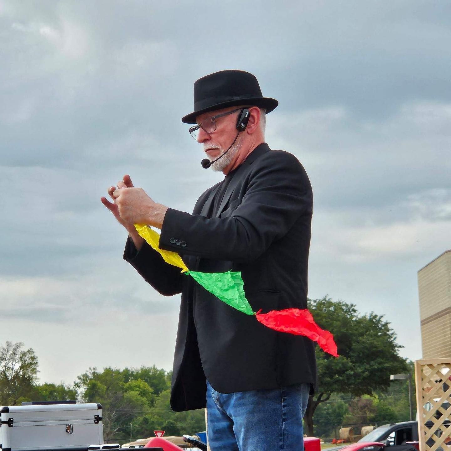 A man wearing a hat and a microphone is performing a trick.
