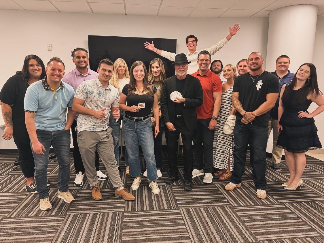 A group of people are posing for a picture in a room.