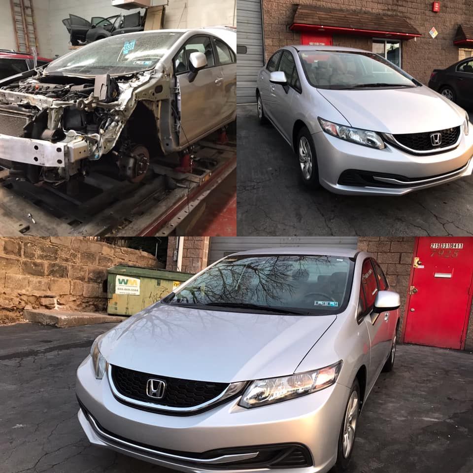 A silver Honda civic is being repaired in a garage