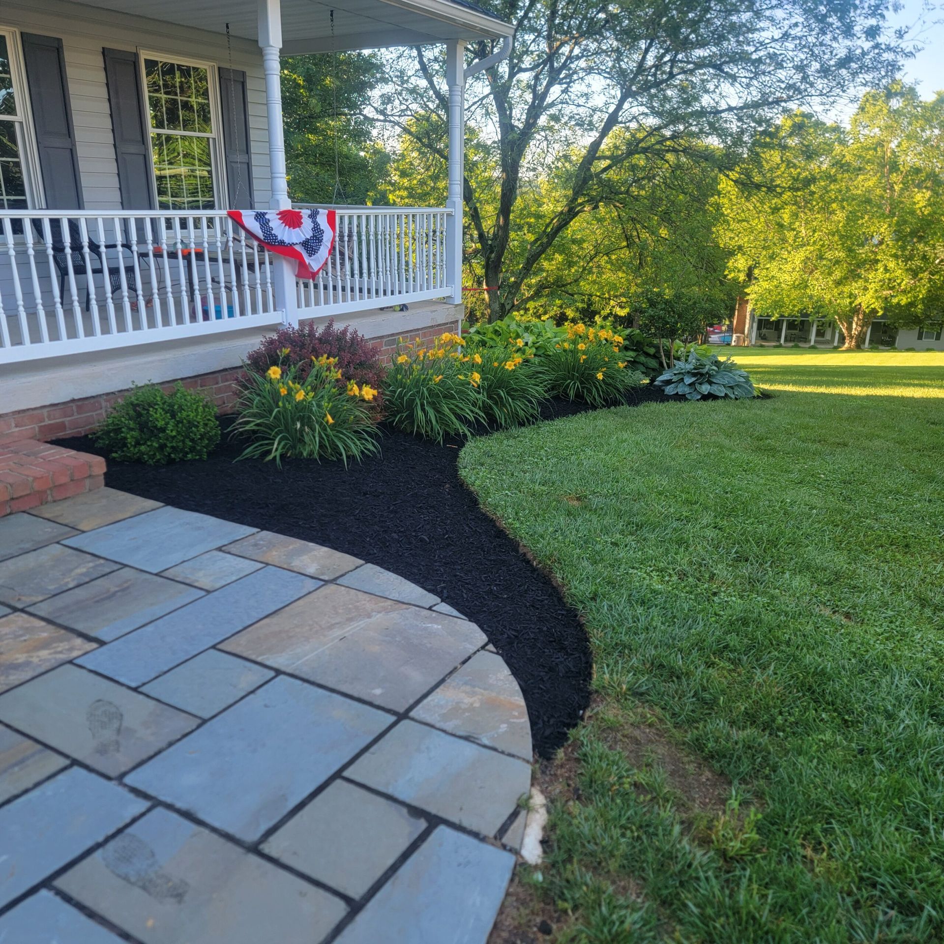 A house with a patio and a flag on the porch