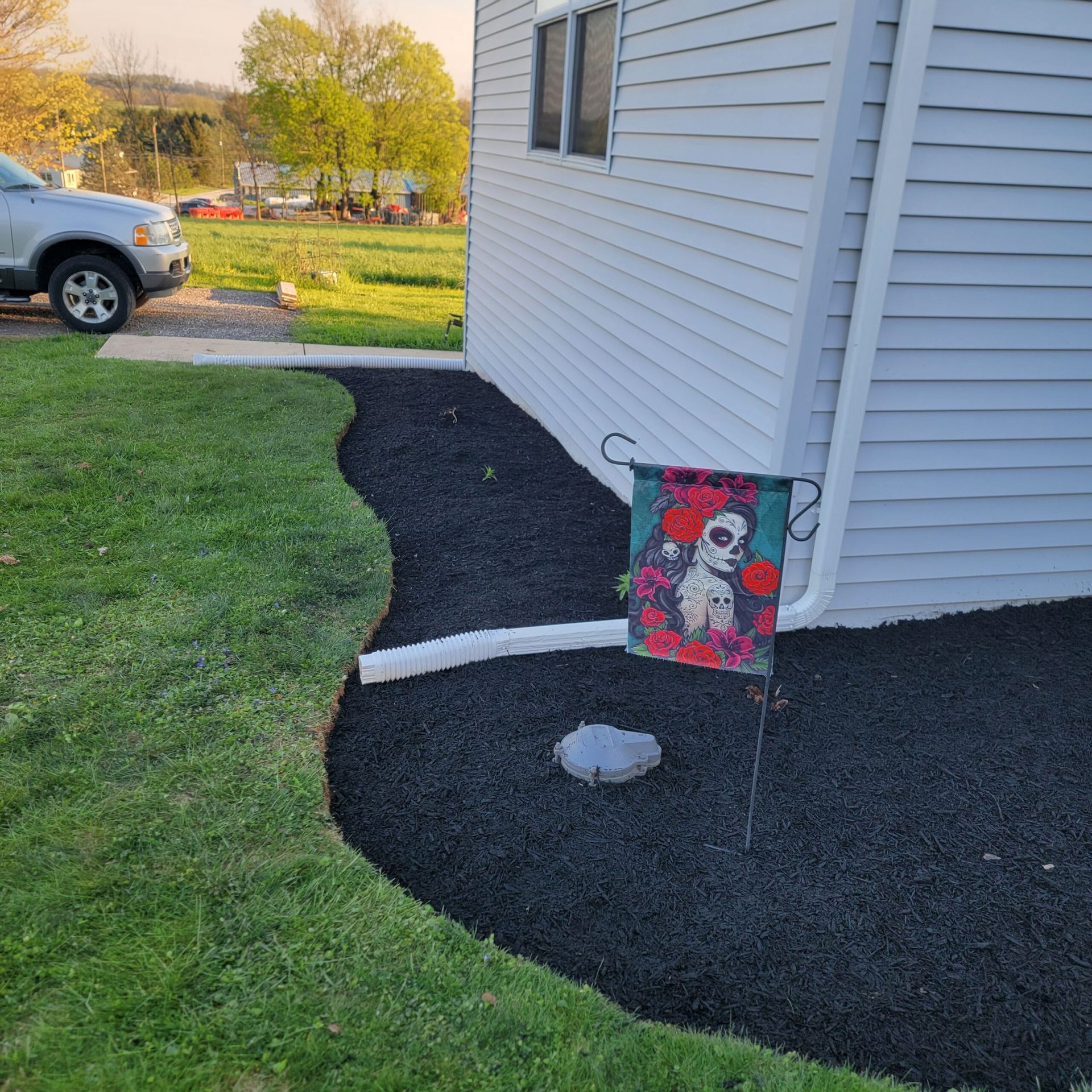 A car is parked in front of a white house