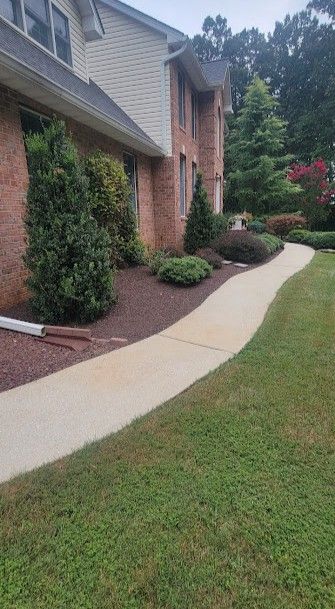 There is a walkway leading to the front of a house.