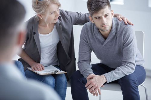 Woman comforting a worried man during a counseling session