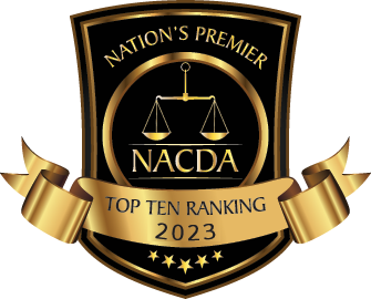 A black and gold NACDA award badge featuring a scale of justice, 
