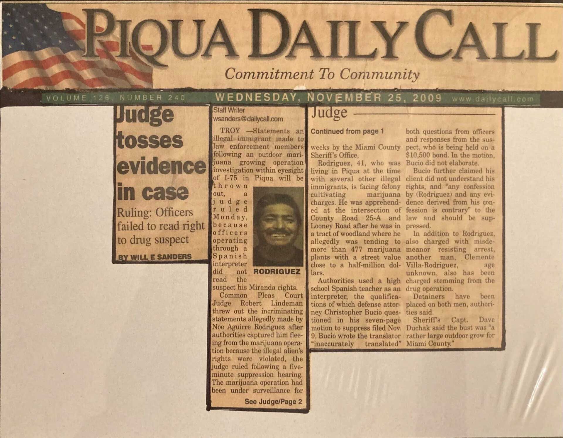 A Piqua Daily Call newspaper front page showing an article about a judge tossing evidence in a case, including a photo.