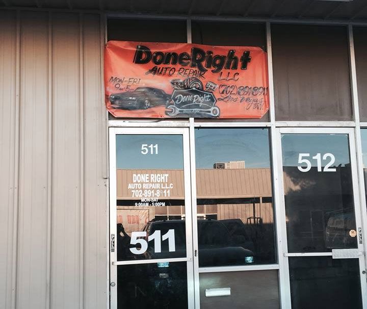 An orange banner for DoneRight Auto Repair LLC hangs above the glass storefronts of units 511 and 512.