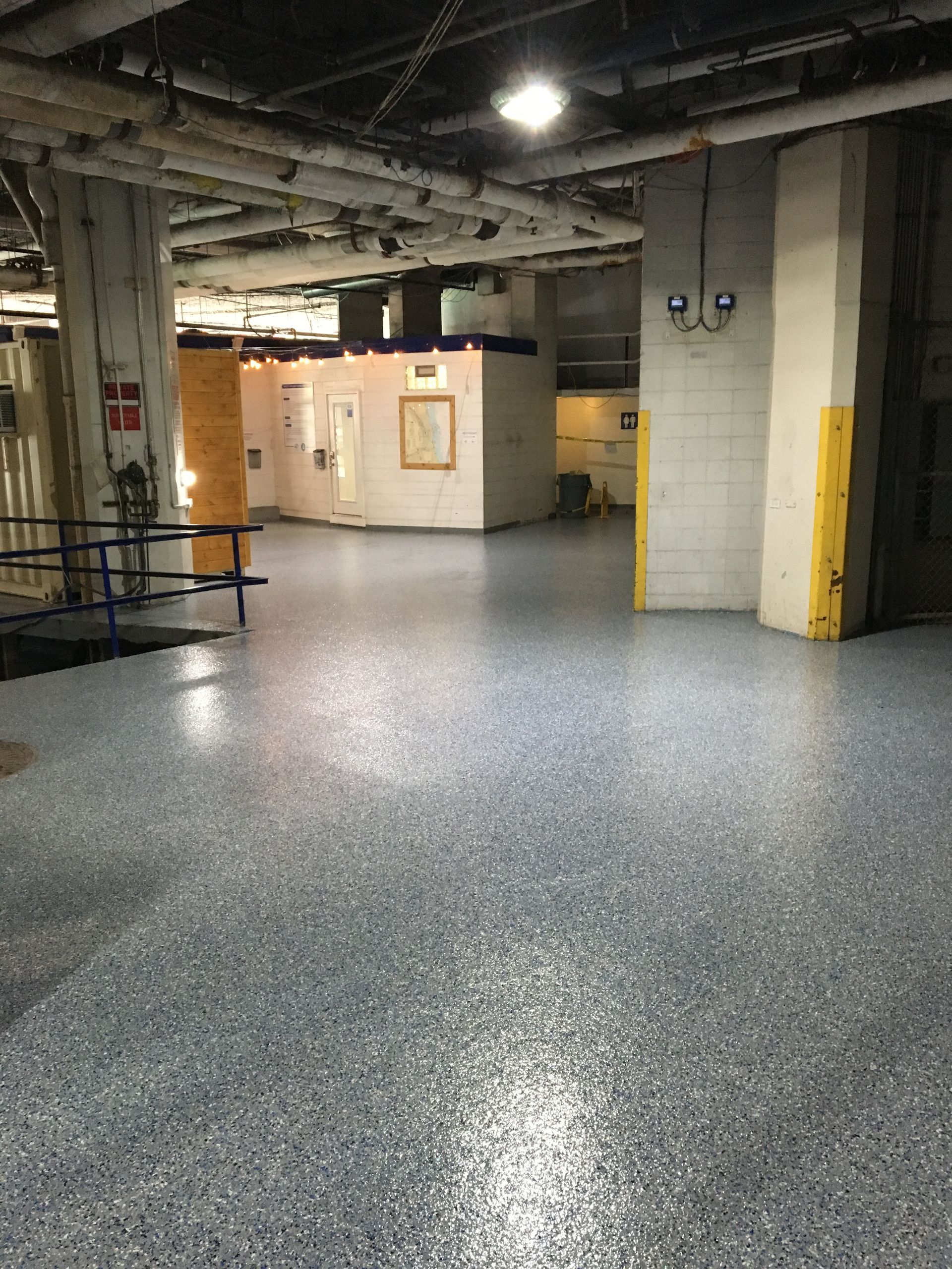a large empty room with a concrete floor