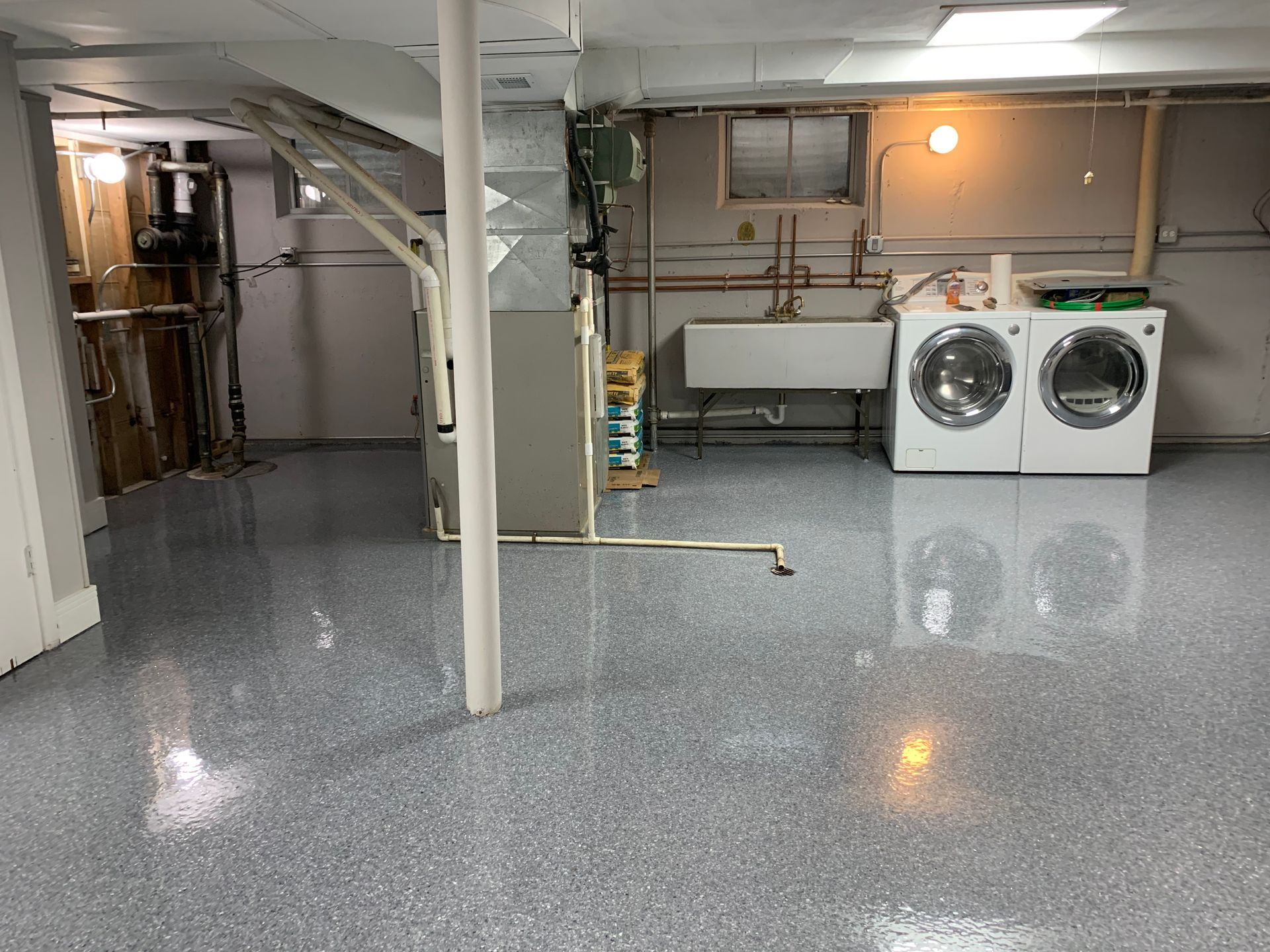 a laundry room with a washer and dryer and a sink